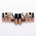 Black and gold designer nails without the case on a white background