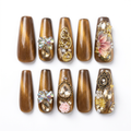 Brown-and-gold designer nails on a white background without the case