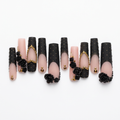 Pink and black designer nails without the case on a white background